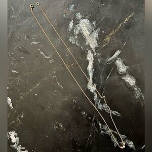 Dogeared gold necklace with three balls (silver, bronze, gold)